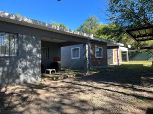 a house with a porch and a yard at Bella Luna apart in Mina Clavero