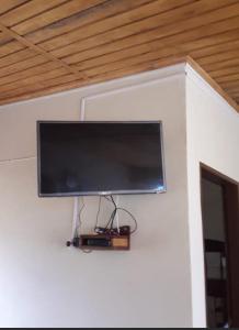 a flat screen tv hanging on a wall at Afecto in San Gregorio de Polanco