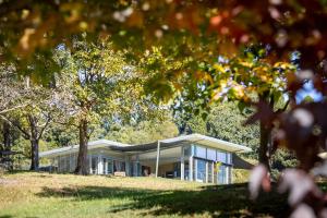 a house in the middle of a park with trees at Origin House Carool in Carool +18 photos