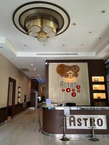 a hotel lobby with a reception desk and a chandelier at Appartment ASTRO Condo in Pak Kret +25 photos