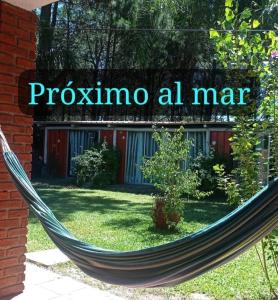 a hammock in a yard with a sign that reads potassium ah mar at Lo de Fede in Punta del Este