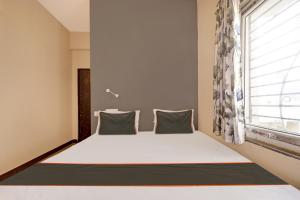 Katil atau katil-katil dalam bilik di Collection O Joya Residency
