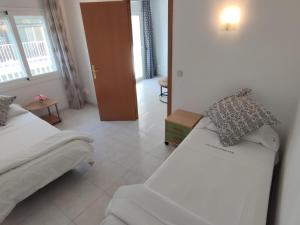 ein Hotelzimmer mit 2 Betten und einem Flur in der Unterkunft Apartamento Platja d'Aro, 3 dormitorios, 6 personas - ES-209-47 in Platja  d'Aro