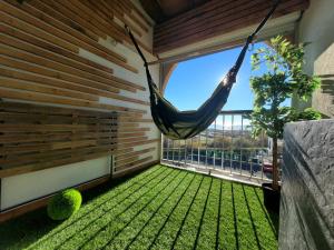 a hammock hanging in a room with a balcony at Appartement Palavas-les-Flots, 2 pièces, 5 personnes - FR-1-715-89 in Palavas-les-Flots