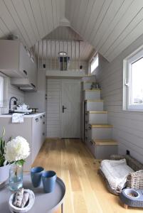 una cucina con scale e un tavolo in una camera di Prześpij się z Alpaką w Tiny House 
