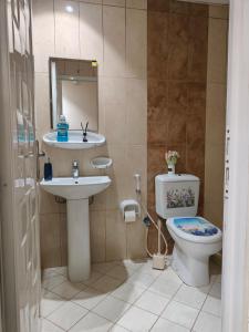 a bathroom with a sink and a toilet at The 1hataman Apartment 'Dubai' in Dubai