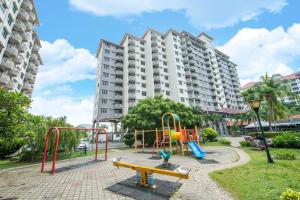 a playground in front of a large apartment building at 3 BEDROOM SEAVIEW CONDO @ GLORY BEACH RESORT, PORT DICKSON in Port Dickson