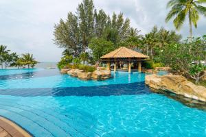 a large swimming pool with a gazebo in a resort at Indra Maya Pool Villas in Lagoi