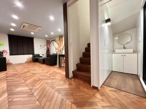 a hallway with a staircase in a home with wooden floors at S-asakusa in Tokyo