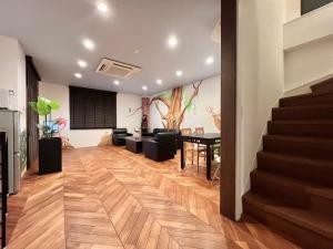 a living room with stairs and a dining room at S-asakusa in Tokyo