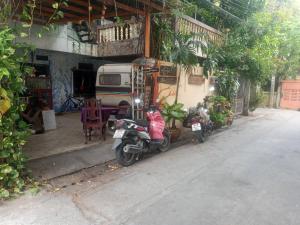 two motorcycles parked in front of a building at Best Place Have Air Conditioner in Bangkok