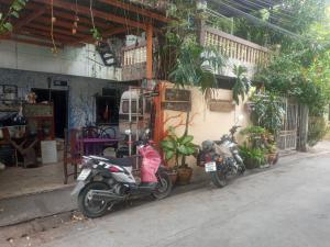 two motorcycles parked in front of a building at Best Place Have Air Conditioner in Bangkok