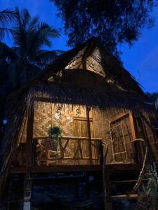 a thatch roofed house with a thatched roof at Malee homestay in Ko Por