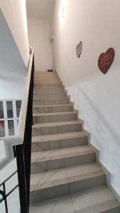 a staircase in a building with a heart on the wall at Nurul Homestay Ajil in Bukit Payong