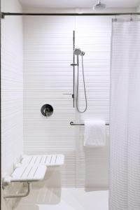 AC Hotel by Marriott Miami Airport West/Doral في ميامي: حمام أبيض مع دش ومرحاض