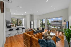 a living room with a couch and a table at Churchill Delux, close to Western health 10 min to Cbd in Braybrook