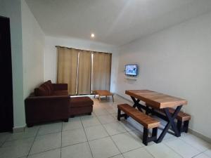 un soggiorno con divano e tavolo di Departamento Azul Marino Cerritos a Mazatlán