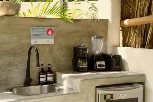 a kitchen counter with a sink and a blender at Casa MexiBali, Palapa Queen in La Majahua