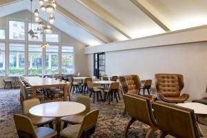 a dining room with tables and chairs and windows at Residence Inn by Marriott Greenbelt in Greenbelt