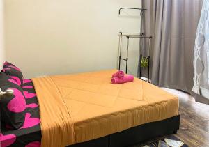 a pink stuffed animal sitting on top of a bed at HOSTEL BLACK88 Airport Transit - Self check in in Sepang