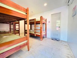 a room with three bunk beds and a doorway at The Escape San Juan in San Juan