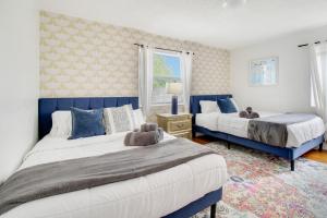 a bedroom with two beds and a window at Rockaway Beach House in West Palm Beach