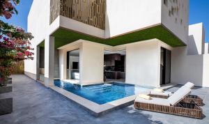 a house with a swimming pool in the yard at The Biltmore Hotel Villas Dubai in Dubai
