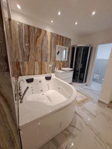 a large bathroom with a tub in the middle at B&B Confort in Reggio di Calabria