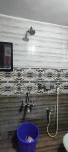 a bathroom with a water faucet and a sink at Kingdom of dorms-the shared room in Chennai