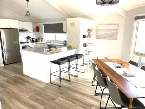 a kitchen and dining room with a table and chairs at Ocean Reach Cape Woolamai in Cape Woolamai