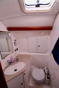 a small bathroom with a sink and a toilet at blu in Cagliari