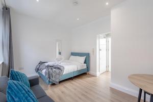 a small bedroom with a bed and a table at HAFH in Paddington - Double studio 2 in London