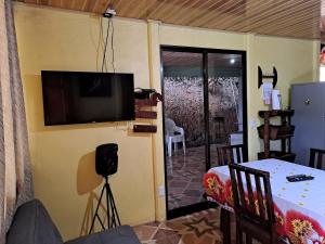 a living room with a flat screen tv on a wall at CASA EQUIPADA SAN IGNACIO DE ACOSTA 