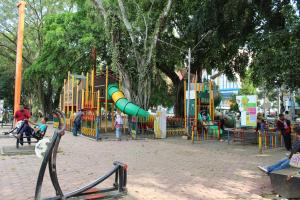 a playground with a slide in a park at Hotel Pelangi Malang, Kayutangan Heritage in Malang