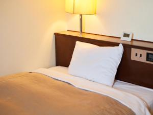 Una cama o camas en una habitación de Tabist Hotel New Central