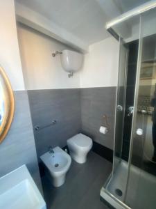 a bathroom with a toilet and a shower at La casa di Leila in Passoscuro +7 photos