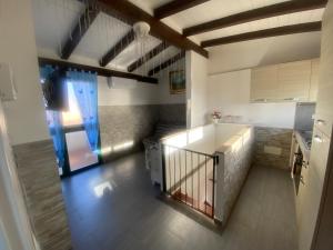 a kitchen with a staircase leading up to a room at La casa di Leila in Passoscuro