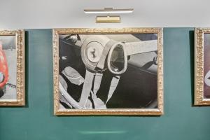 a framed picture of a man in a car on a wall at The London Flat Capital Hill DC in Washington