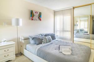a white bedroom with a bed and a mirror at One Bedroom Paradise Steps To Beach - Sleeps 5 in Los Angeles
