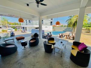 a living room with couches and chairs and a pool at Apartment X5 in Pattaya South +25 photos