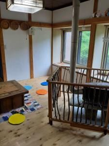 a room with a wooden floor and a spiral staircase at Tanehachi Farm Guesthouse - Vacation STAY 29709v in Aomori