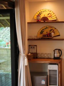 a curtain in a room with a window at Hedreung banrakthai homestay and camping in Ban Rak Thai