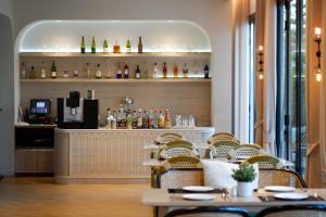 a restaurant with a bar with a table and chairs at Estella Khao Yai in Khao Yai