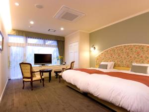 a hotel room with two beds and a desk at Wellness Forest Nasu in Nasu +209 photos