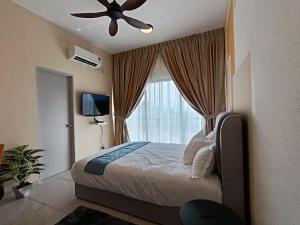 a bedroom with a bed with a ceiling fan and a window at The Horizon Ipoh Dual L13 by Grab A Stay in Ipoh