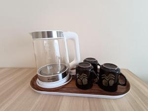 a blender on a wooden tray with two mugs at The Horizon Ipoh Dual L13 by Grab A Stay in Ipoh