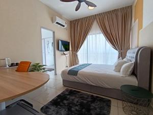 a bedroom with a bed and a table and a window at The Horizon Ipoh Dual L13 by Grab A Stay in Ipoh