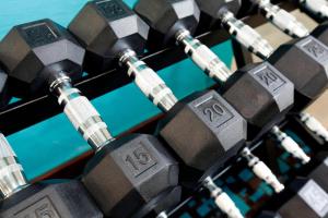 a pile of dumbbells on a poker table at Fairfield Inn & Suites Lansing West in Delta Center Township