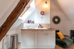 a kitchen with a sink in a attic at Centre-ville le nid d'amour jacuzzi appartement in Rouen