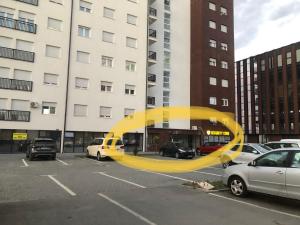 a large yellow sculpture in a parking lot at Klea’s Apartaments in Pristina